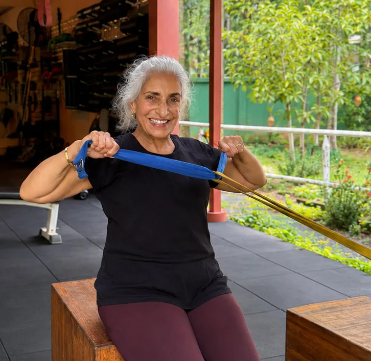 Woman doing resistance band training in the Age Backwards programme at Phuket Cleanse