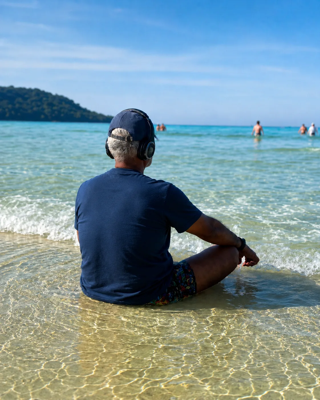 Guest sitting in the shallows at the beach at Phuket Cleanse