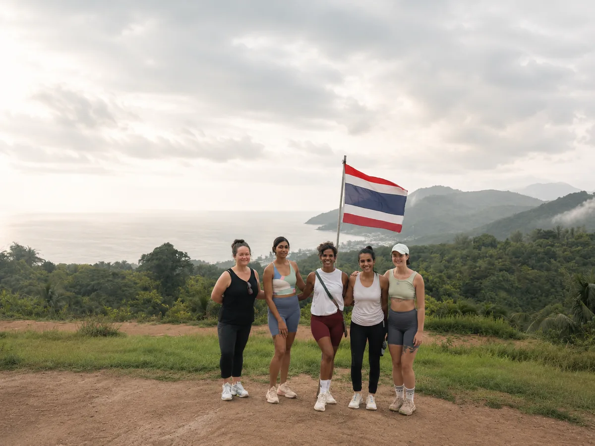 Retreat guests at the hilltop viewpoint with Thai flag, Phuket