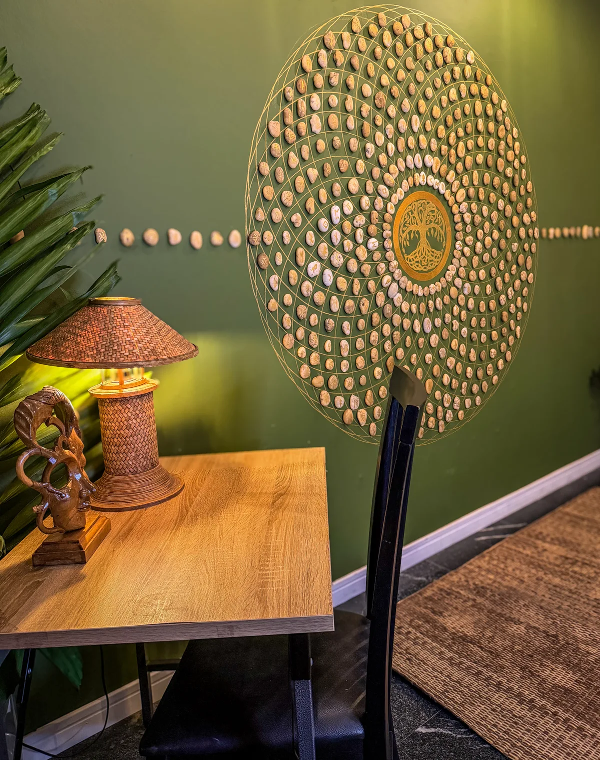 Superior room green wall with rune-stone mandala artwork and woven table lamp at Phuket Cleanse