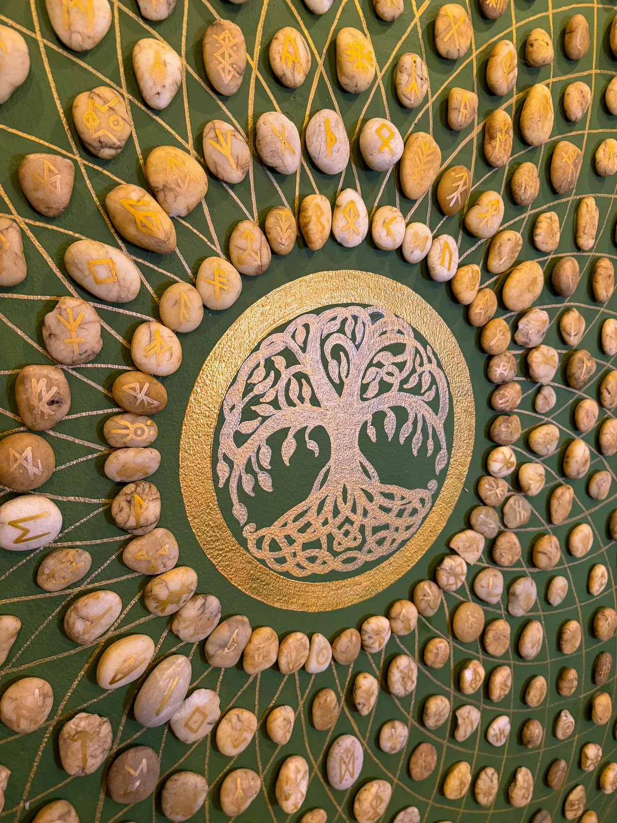 Superior room closeup of hand-crafted rune-stone mandala on green wall at Phuket Cleanse