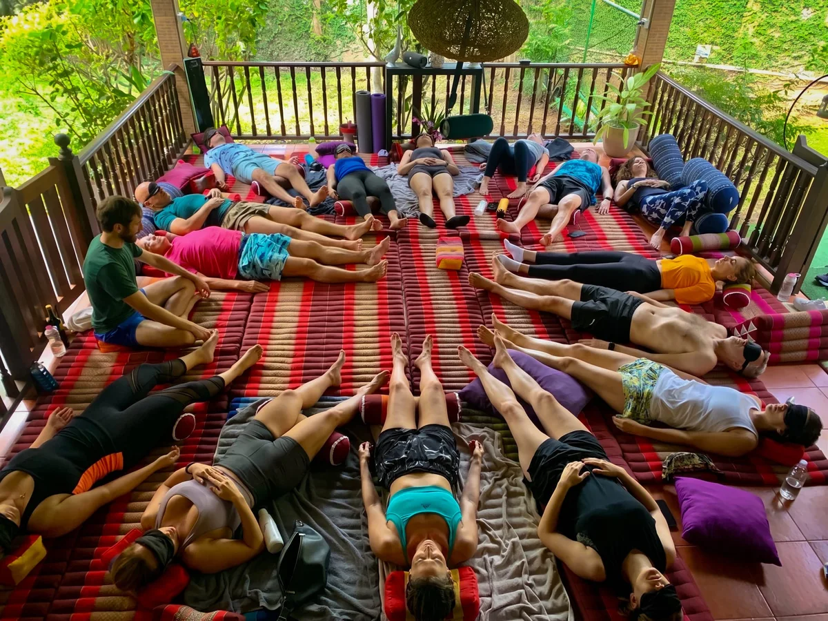 Group lying in breathwork session at Phuket Cleanse — emotional release and transformation